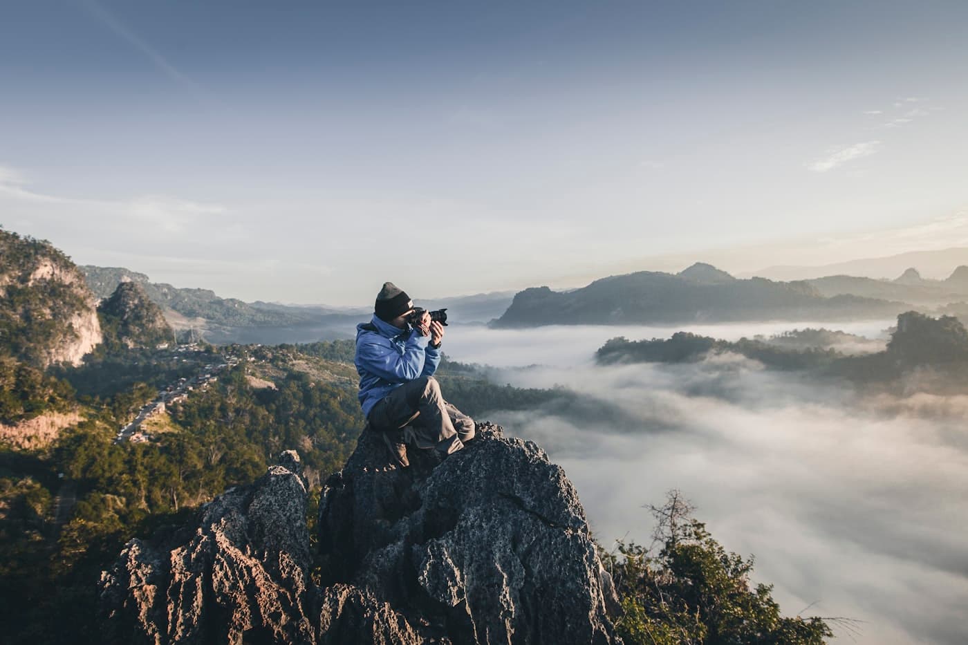 Cinematographer framing a shot at a misty mountain summit